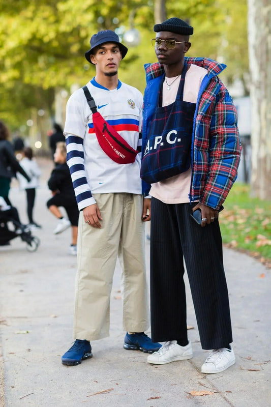 Two stylish men wearing trendy streetwear outfits, showcasing current fashion trends and styles perfect for streetwear discounts promotions.