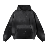 Black hooded sweatshirt with front pocket, featuring abstract art design, oversized fit