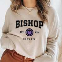 Beige Bishop Hawkeye graphic sweatshirt featuring bold Bishop and Hawkeye text design