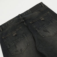 Distressed black denim jeans.