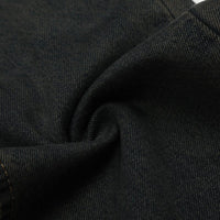 Folded black denim fabric.