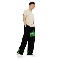 Man in black pants with green flame design.