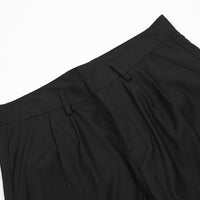 Black pleated trousers.