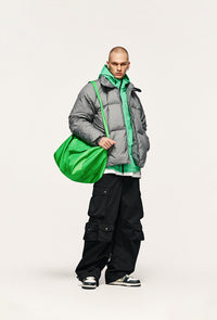 Fashionable man with green bag.