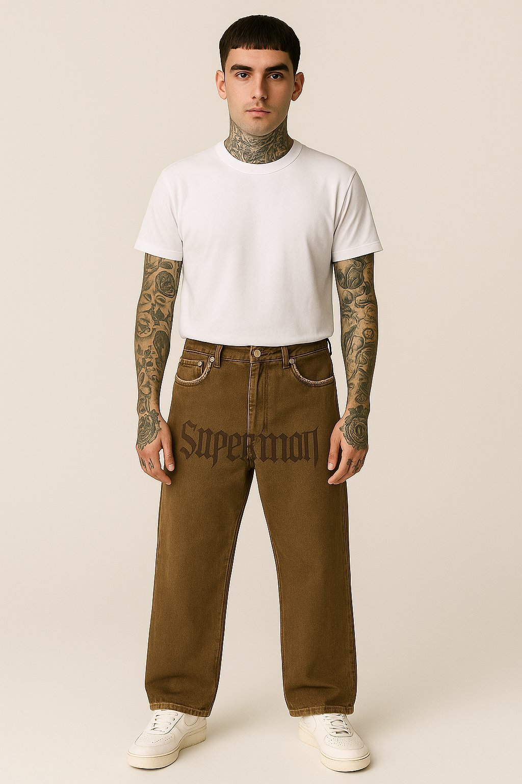 Man wearing brown jeans and a white t-shirt.