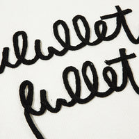 Black cursive lettering on a Distressed Streetwear Knit Sweater