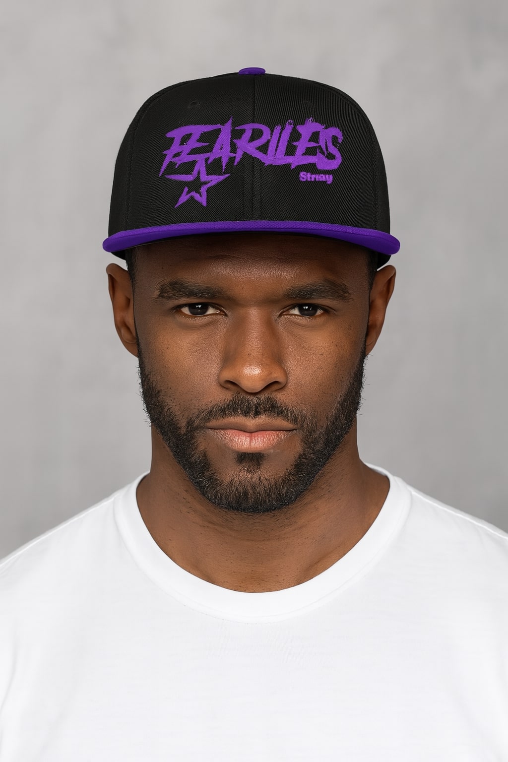 Man wearing a black cap with purple text against a gray background