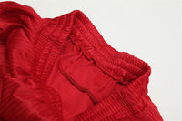 Red Retro Track Pants featuring red athletic shorts with drawstring for a sporty look