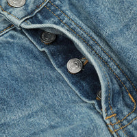 Blue denim button fly.