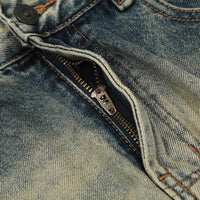 Distressed denim jeans with zipper.